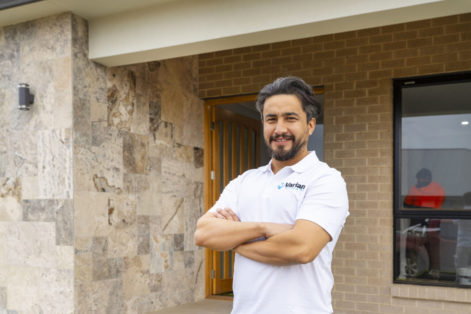 Adelaide tiling specialist standing in front of a freshly restored home exterior